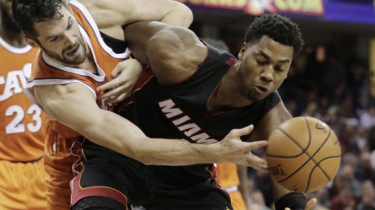 Cleveland Cavaliers' Kevin Love, left and Miami Heat's Hassan Whiteside battle for the ball in the second half of an NBA basketball game Friday, Dec. 9, 2016, in Cleveland. The Cavaliers won 114-84. (AP Photo/Tony Dejak)