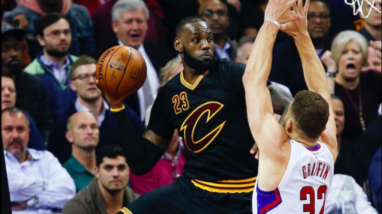 LeBron James (23) saves the ball from going out of bounds against Los Angeles Clippers' Blake Griffin (32)